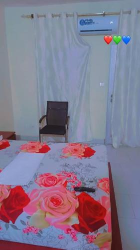 a bedroom with a bed with red roses on it at imobil in Yof