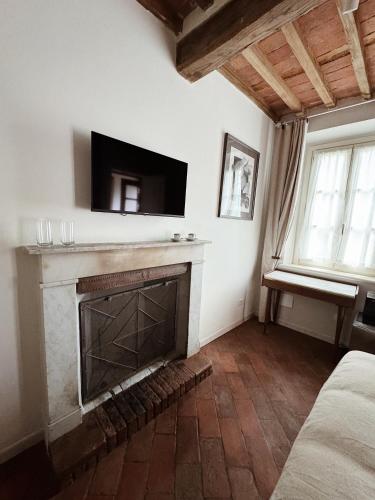 a living room with a fireplace with a flat screen tv at Villa Sofia in Querceta