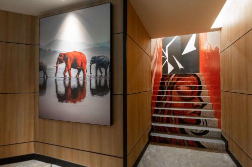 a hallway with a painting of elephants on the wall at Radisson RED Phuket Patong Beach in Patong Beach