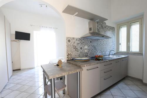 a kitchen with white cabinets and a counter top at La Dolce Vita in Taormina