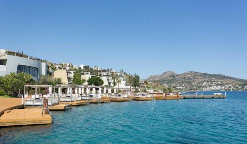 a group of boats docked at a dock on the water at Kuum Hotel & Spa in Golturkbuku