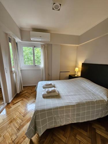 una camera da letto con un letto con due asciugamani sopra di Depto Recoleta Central a Buenos Aires