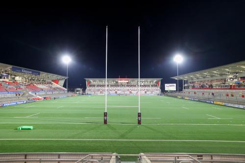 a soccer stadium at night with a soccer field at Ocho Homes by Eight Continents in Belfast