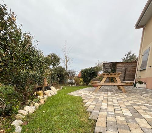 a wooden picnic table sitting on top of a patio at la maison de Luna, cayeux sur mer, baie de somme in Cayeux-sur-Mer