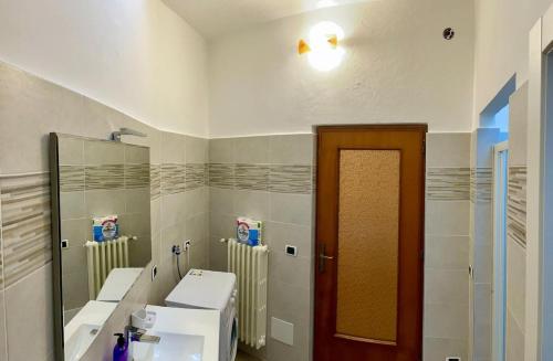 a bathroom with two sinks and two mirrors at Idro Appartamenti - Vantone in IDRO