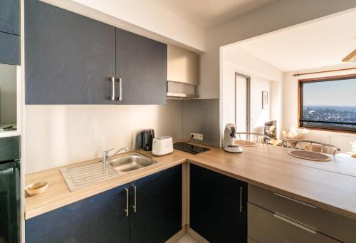 a kitchen with a sink and a counter with a window at Vue imprenable - Garage privé in Rennes