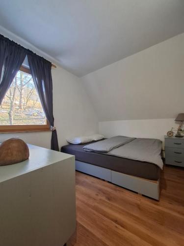 a bedroom with a bed and a window at MontenegrinaBiH, Petrovici, Istocno Sarajevo in Sarajevo