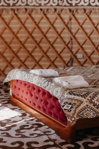 a bed in a yurt with two pillows on it at Ethno complex Ala kuch in Kaindy