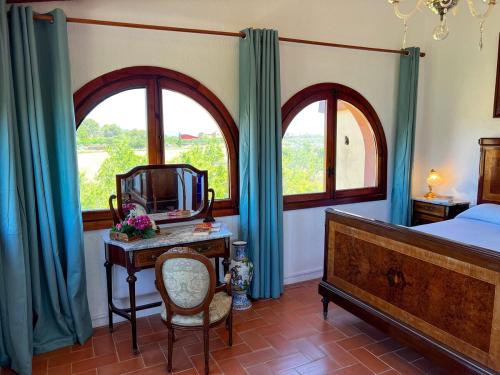 a bedroom with a bed and a desk with a mirror at La Noguera by Unik Vacation in Valls