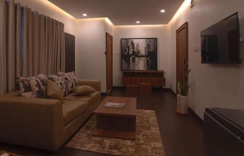 a living room with a couch and a coffee table at WACOP HOTEL & CONFERENCE CENTRE, Gaduwa, Abuja in Abuja