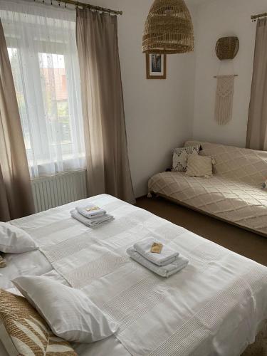 a bedroom with two beds with towels on them at Sandomiria in Sandomierz