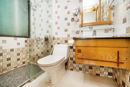 a bathroom with a toilet and a shower at Ocean Bliss Hotel - Free Sauna in Da Nang