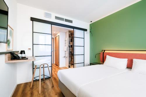 a bedroom with a bed and a table and a stool at Hotel Convictus Cracovia for business & travellers in Kraków