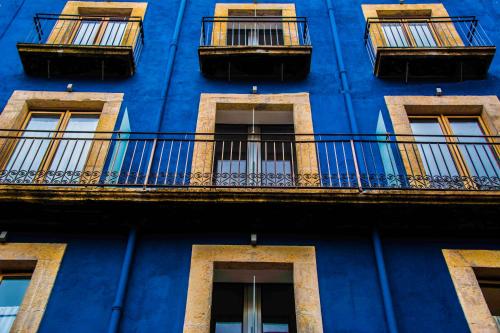 a blue building with balconies on the side of it at Pigal in Tarragona