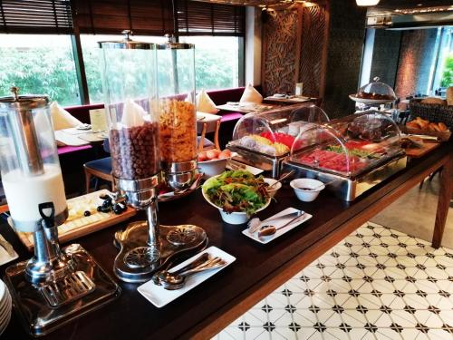 a buffet line with many different types of food at SILA Urban Living in Ho Chi Minh City