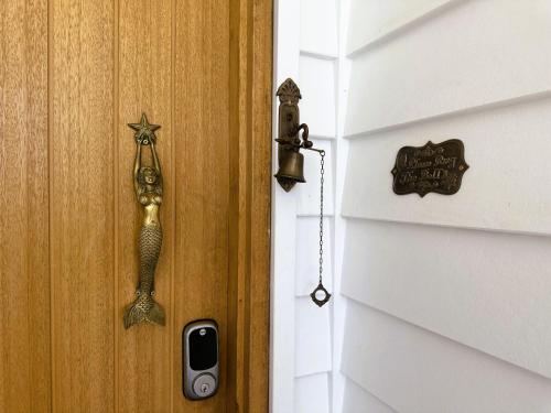 a door with a seahorse hanging on it at The Mermaid's Retreat - Pool in Kiama! in Kiama