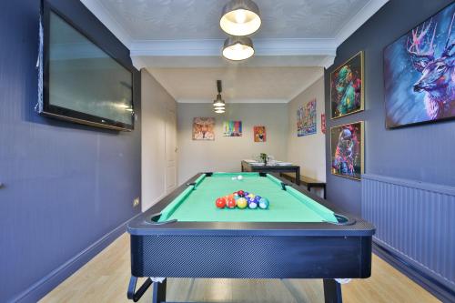 a room with a pool table in it at Spacious & Modern Triple-Story Cardiff Home with Pool Table in Cardiff