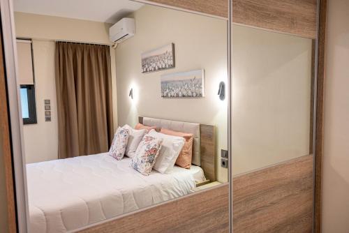 Un dormitorio con una cama y una pared de cristal. en Anora Apartment, en Preveza