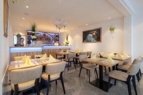 a restaurant with tables and chairs and a bar at Hotel Johannisberg Bad Homburg in Bad Homburg vor der Höhe