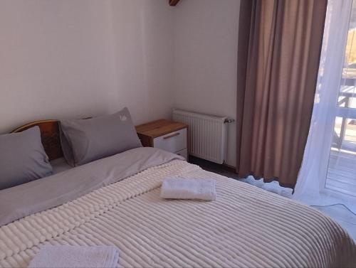 a bedroom with a bed with a towel on it at Ехо Тростяну in Slavske
