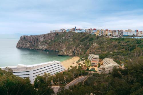 a view of a beach with buildings on a hill at Mercure Quemado Al-Hoceima Resort in Al Hoceïma