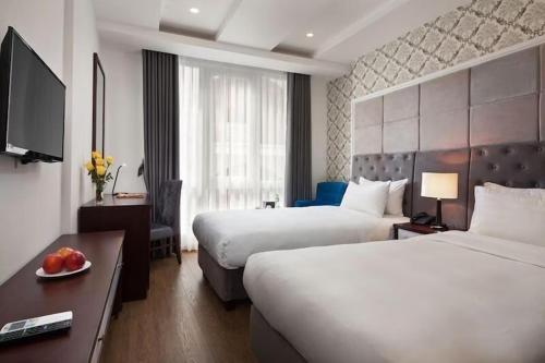 Postel nebo postele na pokoji v ubytování Skyline Hanoi Hotel