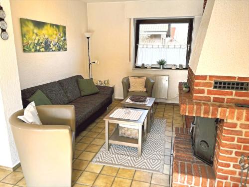 a living room with a couch and a fireplace at Ferienhaus Wacholderhain in Haselünne