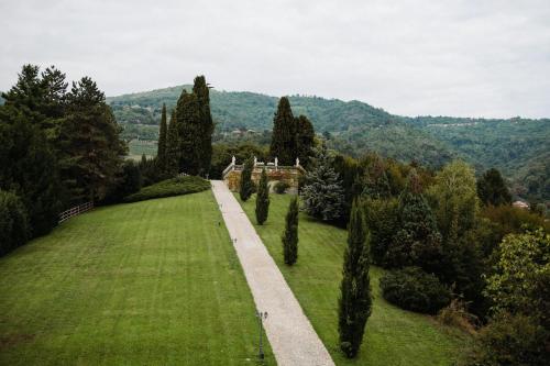 a path through a field of grass with trees at Villa Lucini 1886 Garden Apt near Lake Como and Milan in Rovagnate