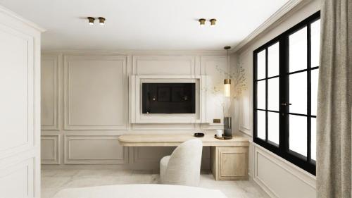 a white room with a desk and a television at Hôtel Maison Turenne in Martel