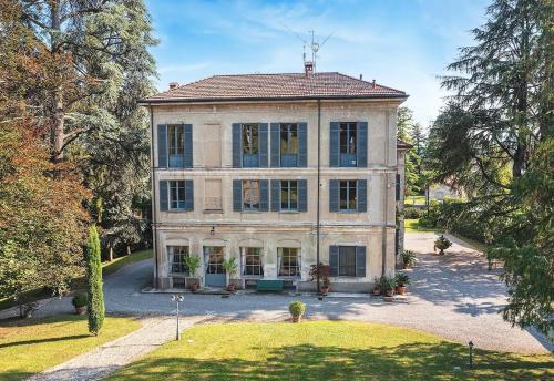 a large stone house with a lot of windows at Villa Lucini 1886 Garden Apt near Lake Como and Milan in Rovagnate