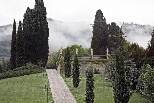 a house in the middle of a field with trees at Villa Lucini 1886 Garden Apt near Lake Como and Milan in Rovagnate