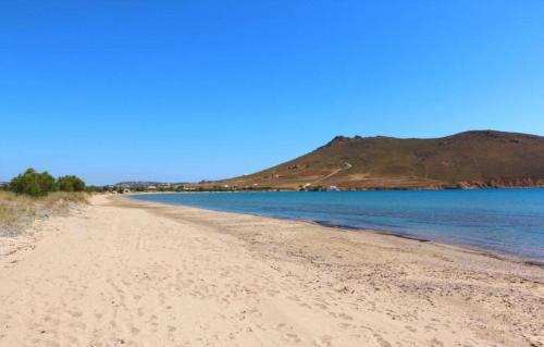 a view of a beach with a mountain in the background at Marilous House - Skyros Beachfront Getaway in Skiros