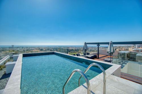 a swimming pool on the roof of a building at Prestige 403 1 BED in Paphos