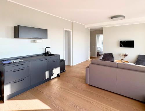 a living room with a couch and a tv at Westeroog in Wangerooge