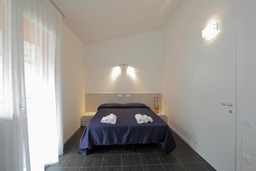 a bedroom with a bed with two towels on it at Residence Città Ideale in Urbino