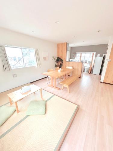 a living room with a table and a dining room at Ueno 3m to Train 161m2 Villa 6BR 3Bath 4Toilet Skytree View in Tokyo