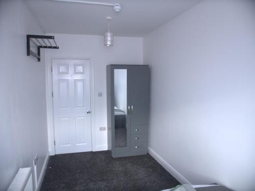 an empty room with a door and a hallway at Stylish 4 Bd Ft LDN Parking in London