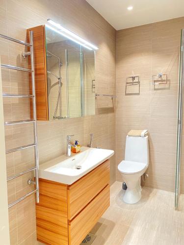 a bathroom with a sink and a toilet at Luxury City Seafront Apartment with Balcony in Helsinki