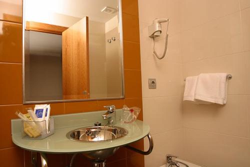 a bathroom with a sink and a mirror at AB Murias Blancas in Villaviciosa