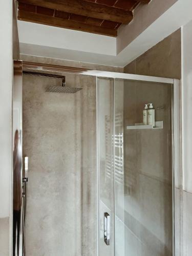 a shower with a glass door in a bathroom at Villa Sofia in Querceta