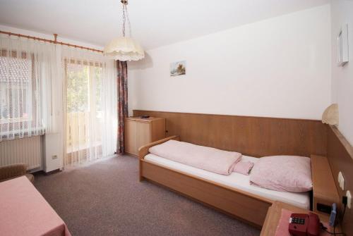 a bedroom with a bed and a large window at Pension Schwaiger in Bad Gögging