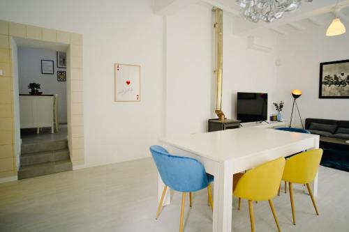 a dining room with a white table and blue chairs at Casa da Serra - Entire 3 Bedroom House with Pool and Fireplace in Monchique