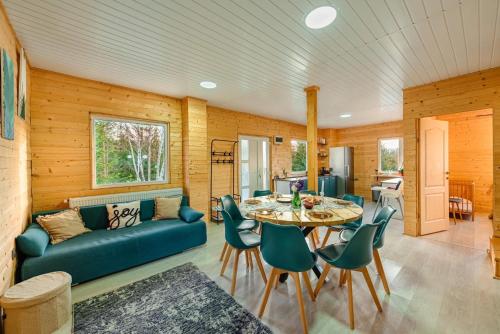a living room with a blue couch and a table at Apusenity- Refugiu modern în inima naturii, aproape de Cluj in Cluj-Napoca