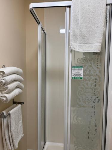 a shower with a glass door in a bathroom at Marlow Lodge in Blackpool