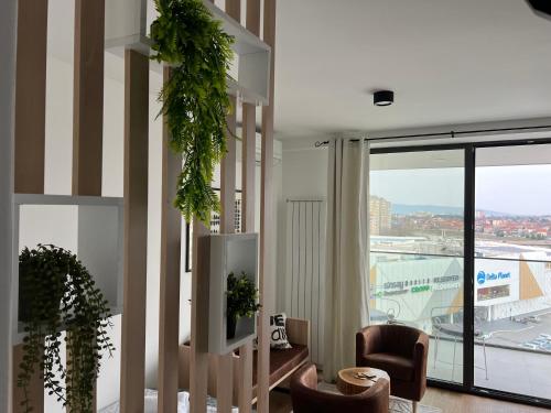 a living room with chairs and a large window at LiboroPlanet in Niš