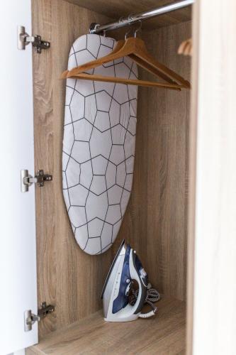 a bathroom door with a toilet and a mirror at Simply Modern Apartments in Toruń