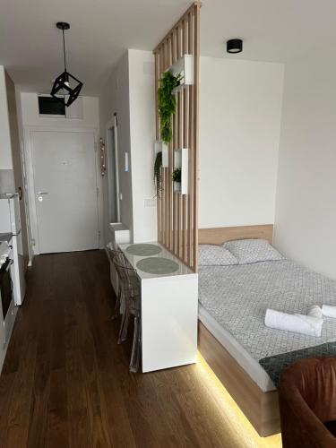a bedroom with a bed and a table and chairs at LiboroPlanet in Niš