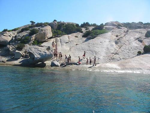 a group of people jumping off a cliff into the water at Casa Marina Maria in Murta Maria