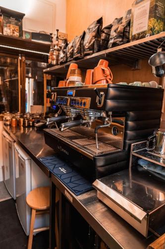a machine sitting on top of a counter in a kitchen at London Visitors Hotel in London