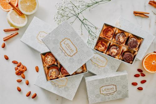 three boxes of pastries on a table with orange slices at Casa das Lérias in Amarante